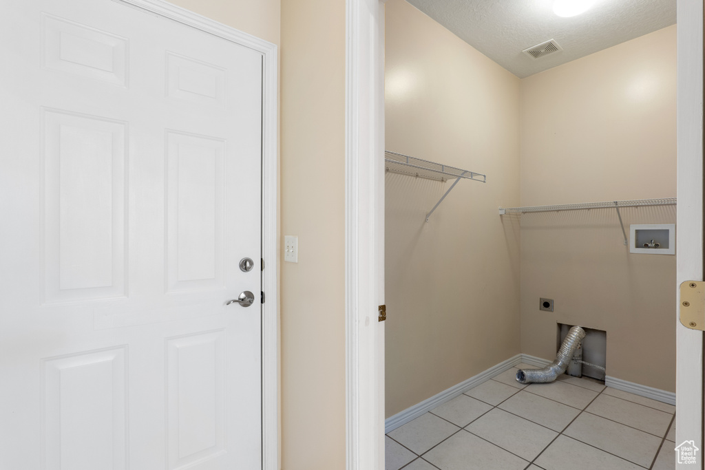 Washroom with laundry area, hookup for a washing machine, baseboards, hookup for an electric dryer, and visible vents