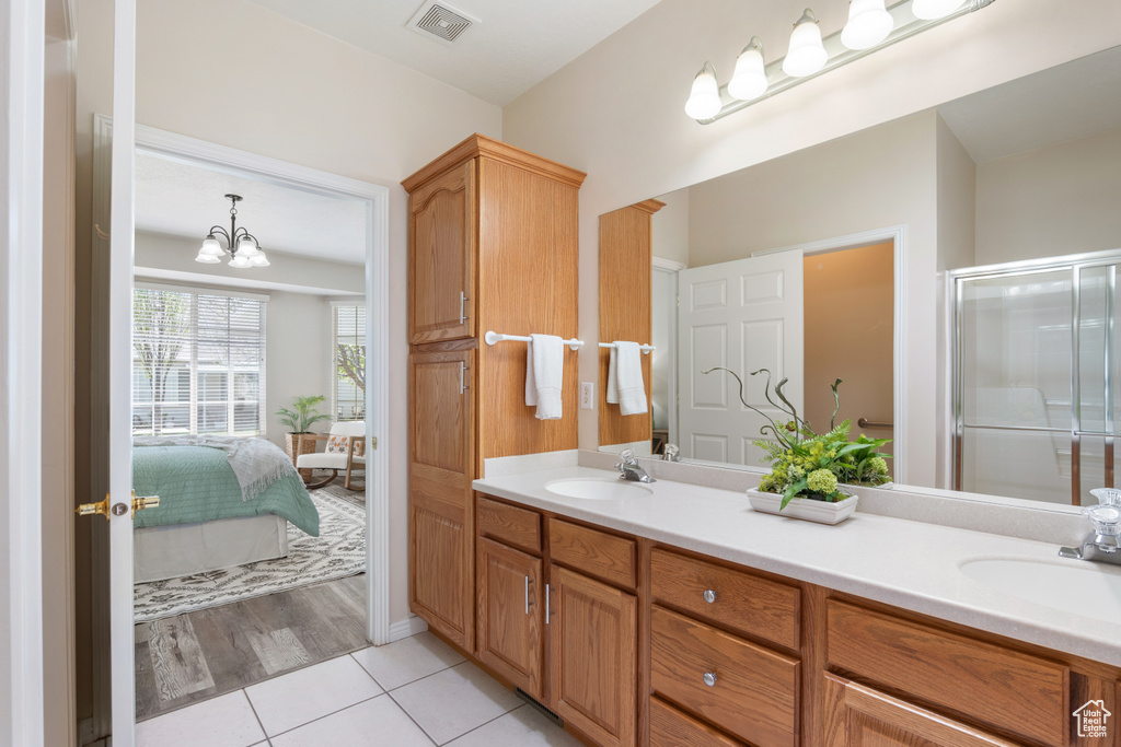 Full bath with a sink, tile patterned flooring, double vanity, and visible vents