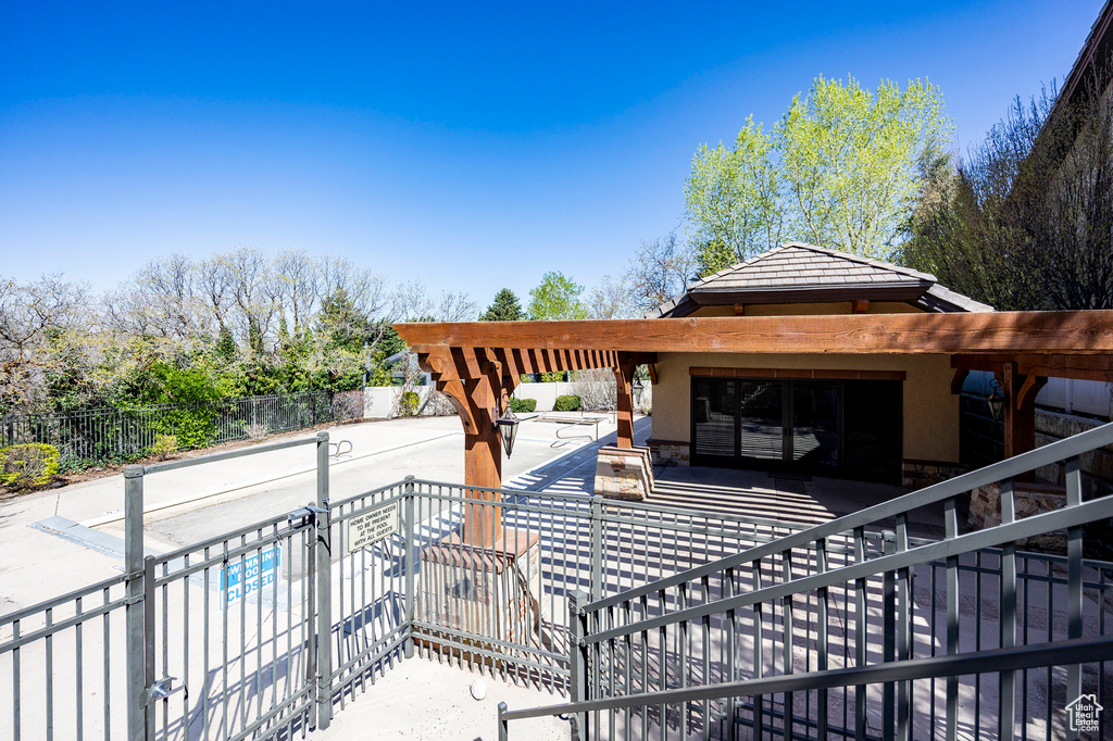 Wooden terrace featuring fence and a patio area