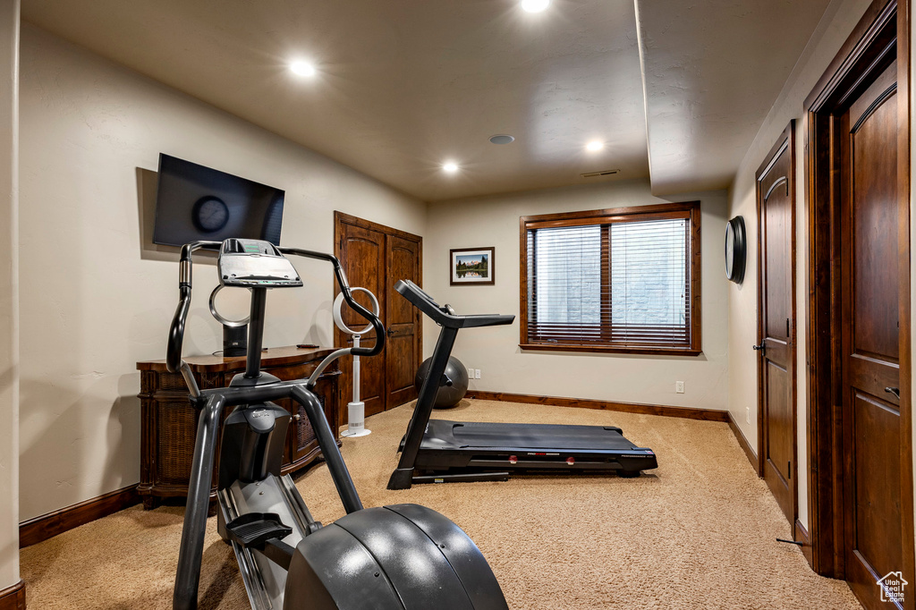 Exercise room with light colored carpet, recessed lighting, and baseboards