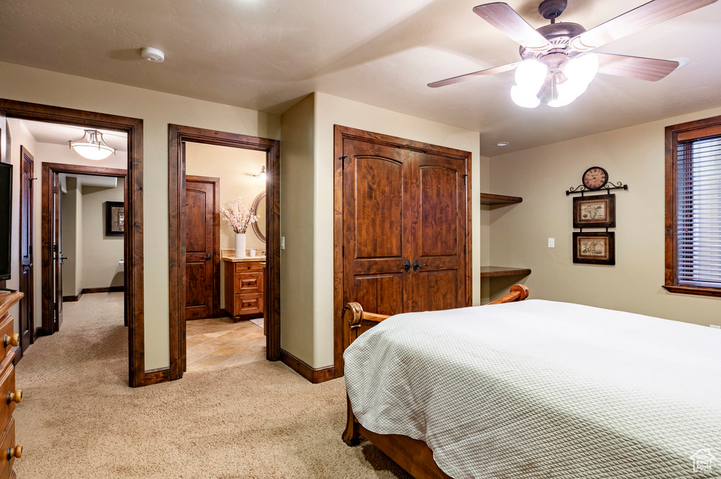 Bedroom featuring baseboards, a ceiling fan, and light carpet