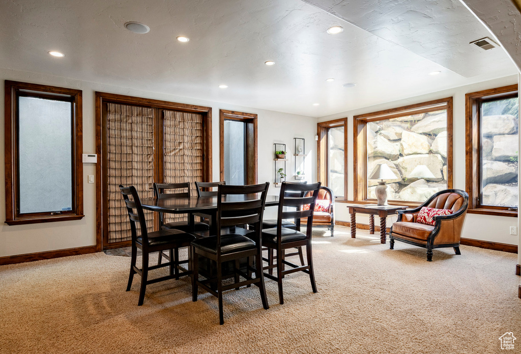 Dining space featuring recessed lighting, baseboards, light colored carpet, and visible vents