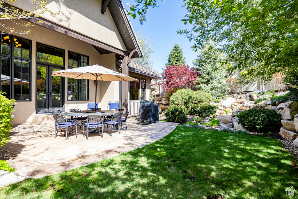 View of yard with a patio and french doors