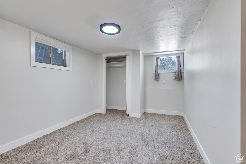 Unfurnished bedroom featuring baseboards, carpet, and a closet