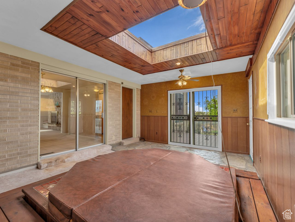Unfurnished sunroom with a skylight