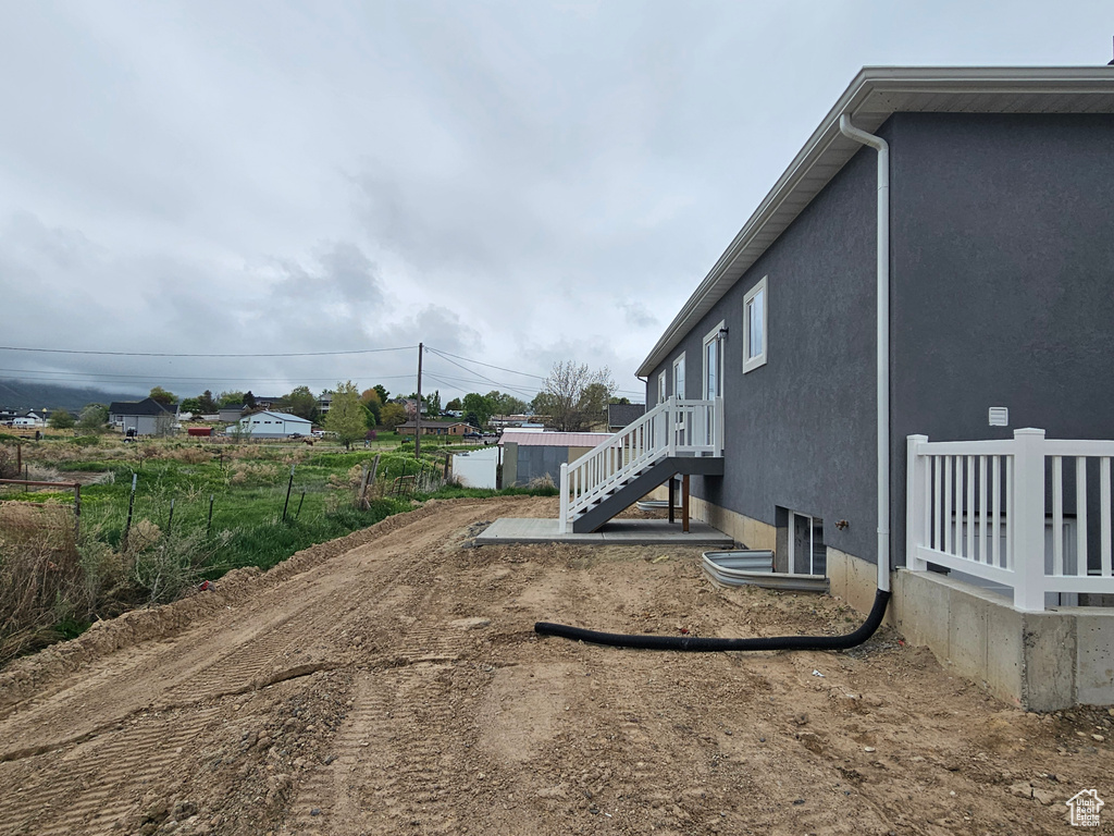 Exterior space featuring stairs and stucco siding