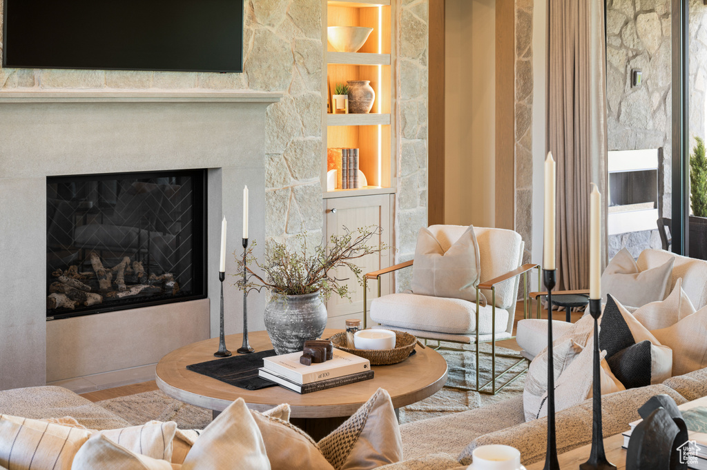 Living room with a glass covered fireplace and built in shelves