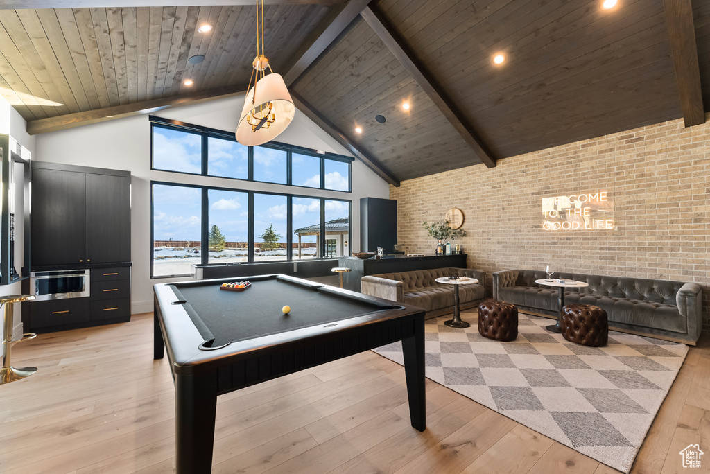 Rec room featuring beamed ceiling, high vaulted ceiling, pool table, wooden ceiling, and light wood finished floors