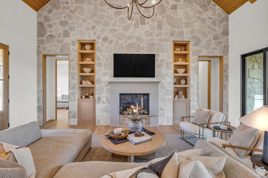 Living room with wood ceiling, a fireplace, and high vaulted ceiling
