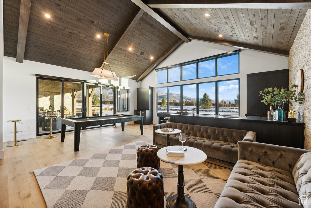 Game room with beam ceiling, high vaulted ceiling, hardwood / wood-style floors, pool table, and wood ceiling