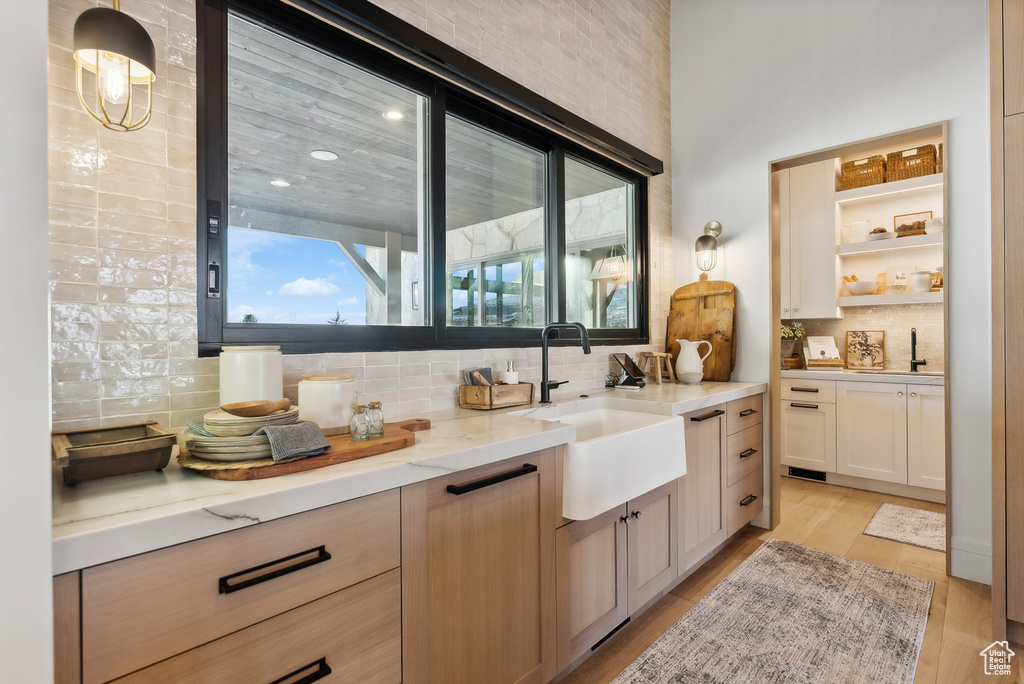 Bathroom featuring backsplash, recessed lighting, wood finished floors, and vanity