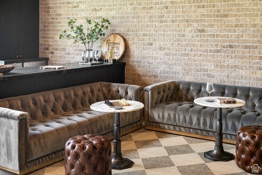 Sitting room featuring brick wall
