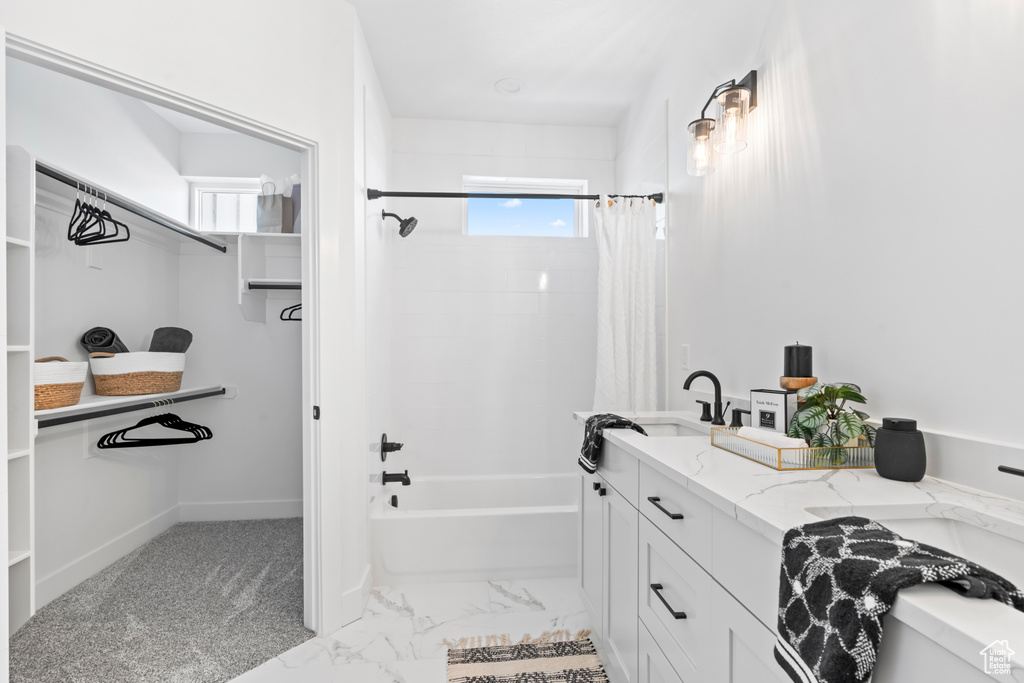Full bathroom featuring shower / bath combo with shower curtain, a healthy amount of sunlight, a spacious closet, and vanity