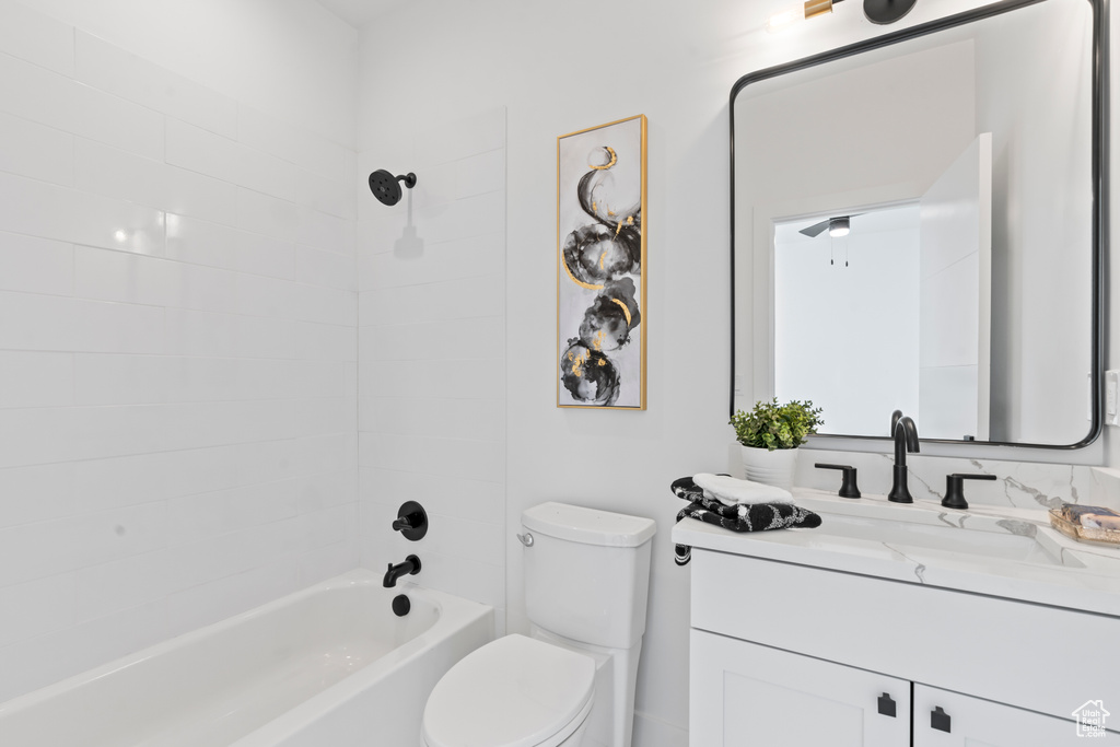 Full bath featuring vanity, shower / bath combination, and toilet