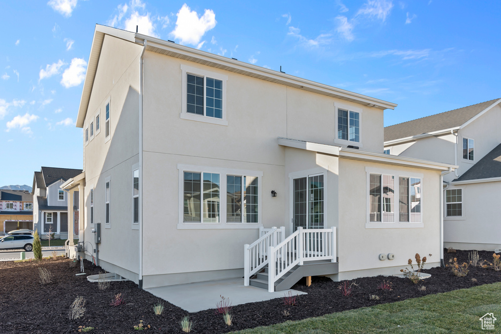Back of property featuring stucco siding