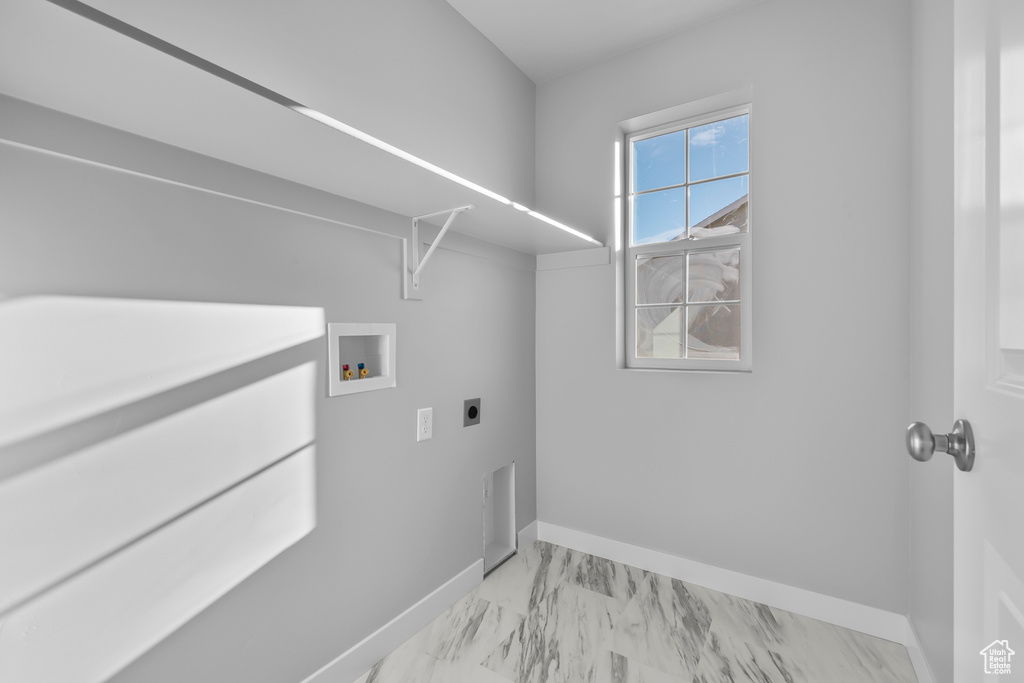 Clothes washing area featuring laundry area, marble finish floor, baseboards, hookup for a washing machine, and electric dryer hookup