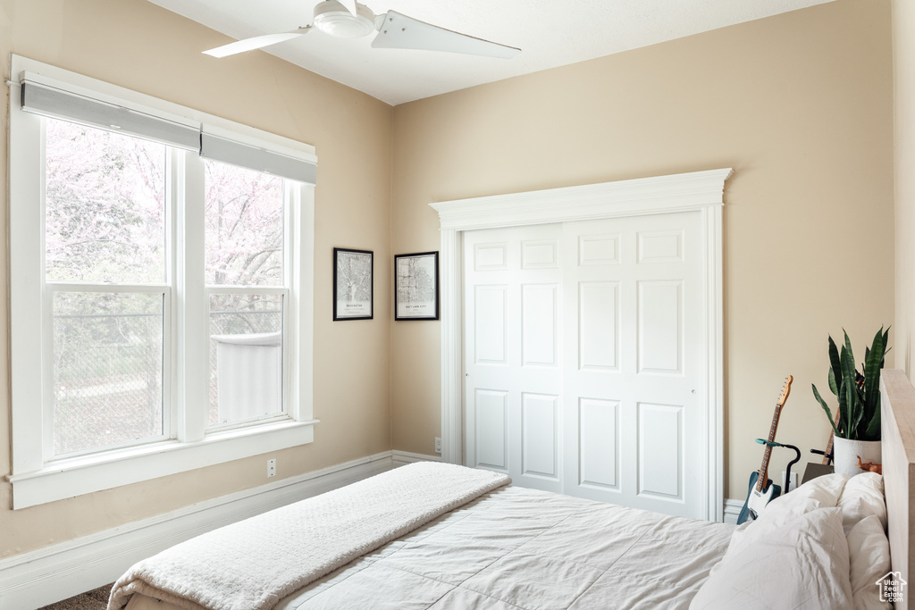 Bedroom featuring a ceiling fan and a closet