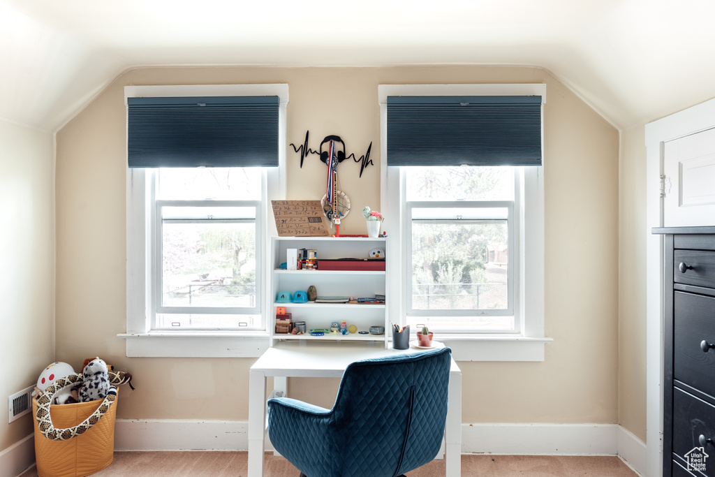 Interior space featuring baseboards and lofted ceiling