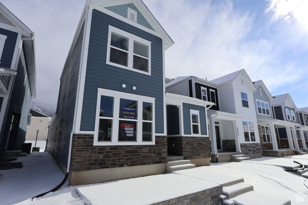 View of front facade featuring a residential view and stone siding