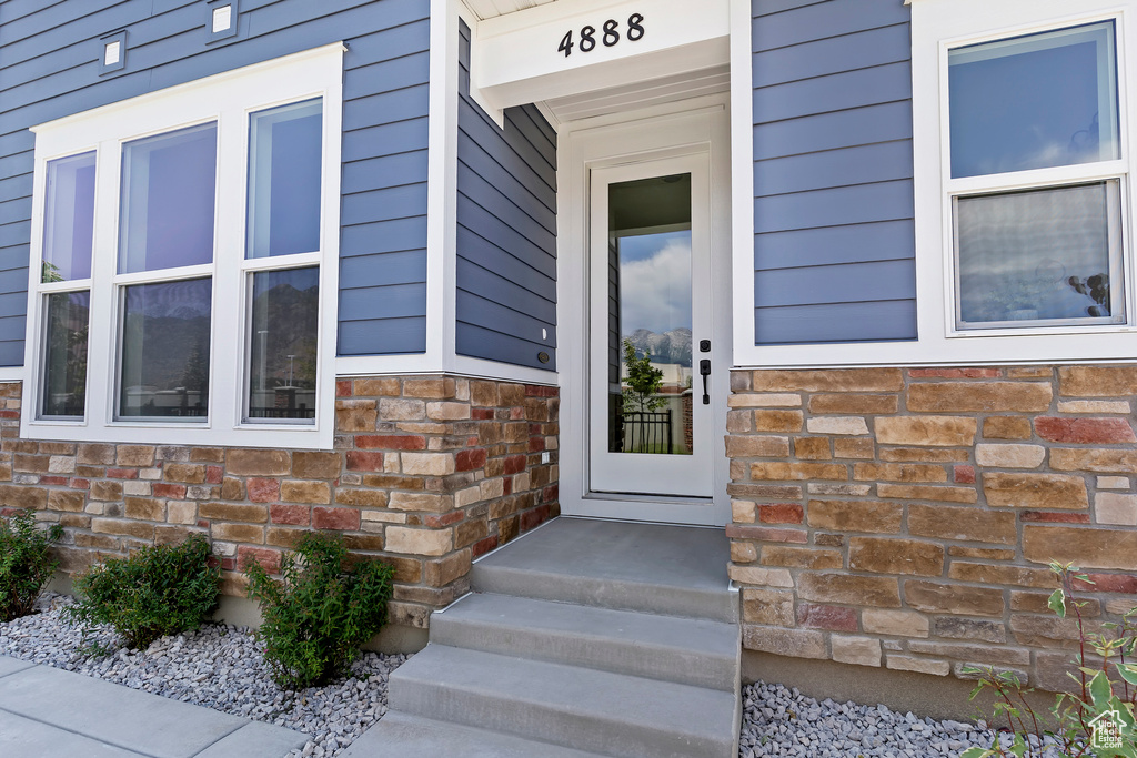 Property entrance with stone siding