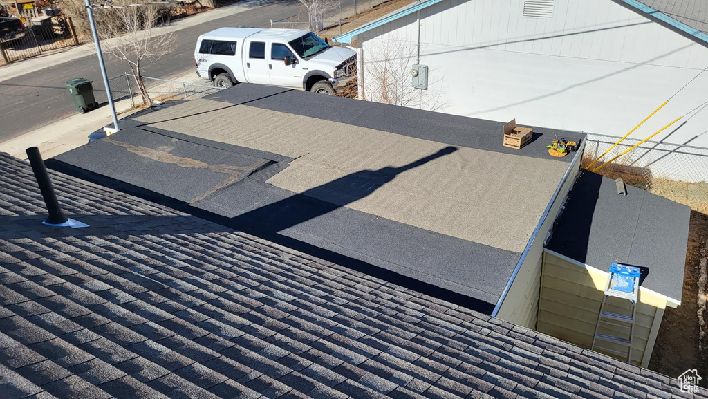 Exterior details with fence and roof with shingles