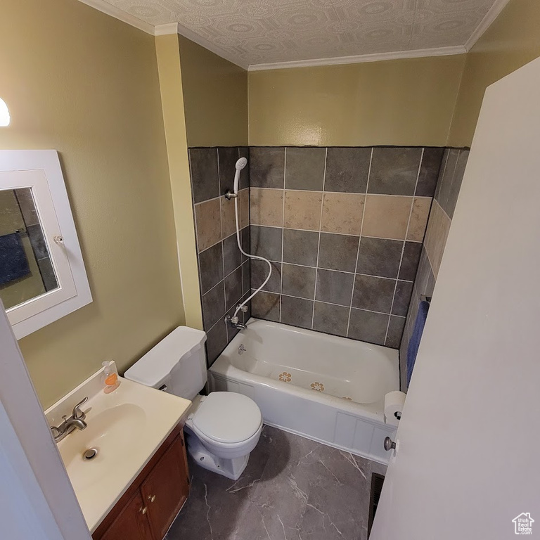 Full bathroom with crown molding, vanity, toilet, marble finish floor, and shower / washtub combination