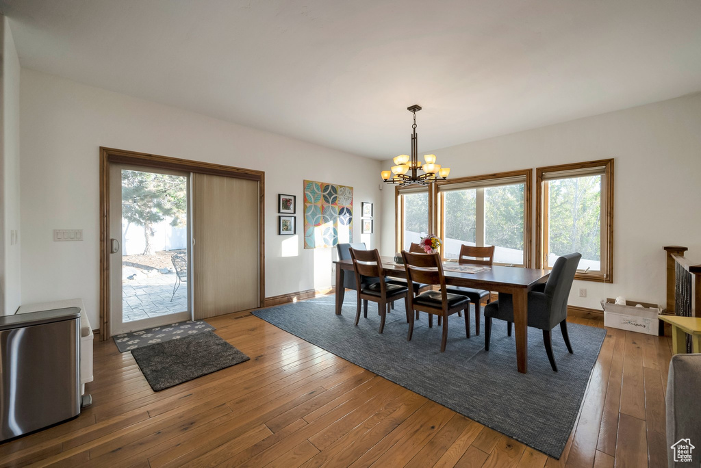 Dining space featuring an inviting chandelier and hardwood / wood-style floors
