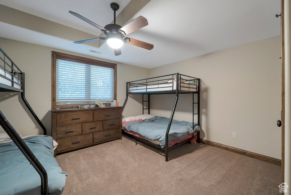 Bedroom featuring visible vents, ceiling fan, and light colored carpet