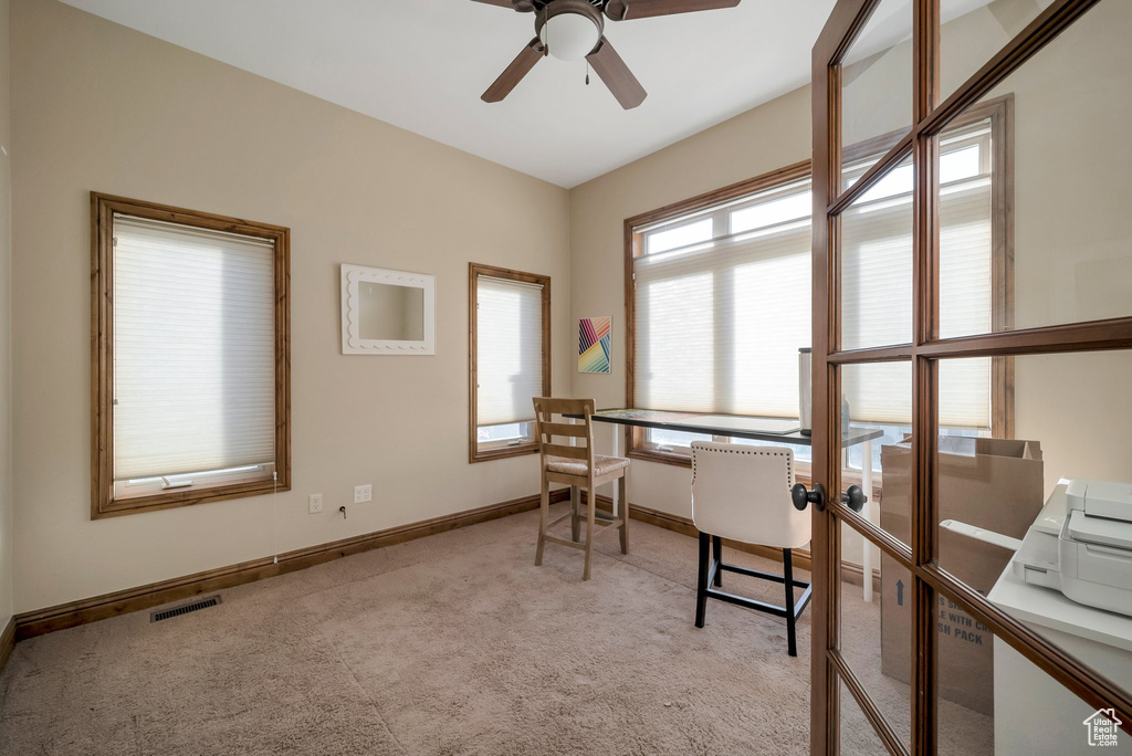 Office with visible vents, a ceiling fan, baseboards, and light colored carpet