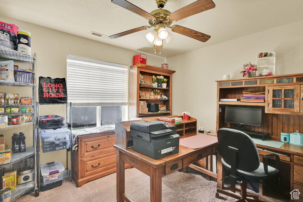 Office area featuring a ceiling fan, light colored carpet, and visible vents