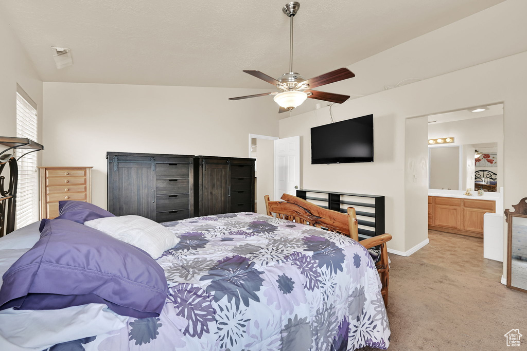 Bedroom with baseboards, ceiling fan, ensuite bath, and light colored carpet
