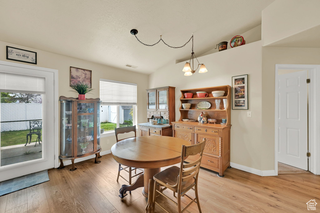 Dining space featuring light wood-style floors, baseboards, and visible vents
