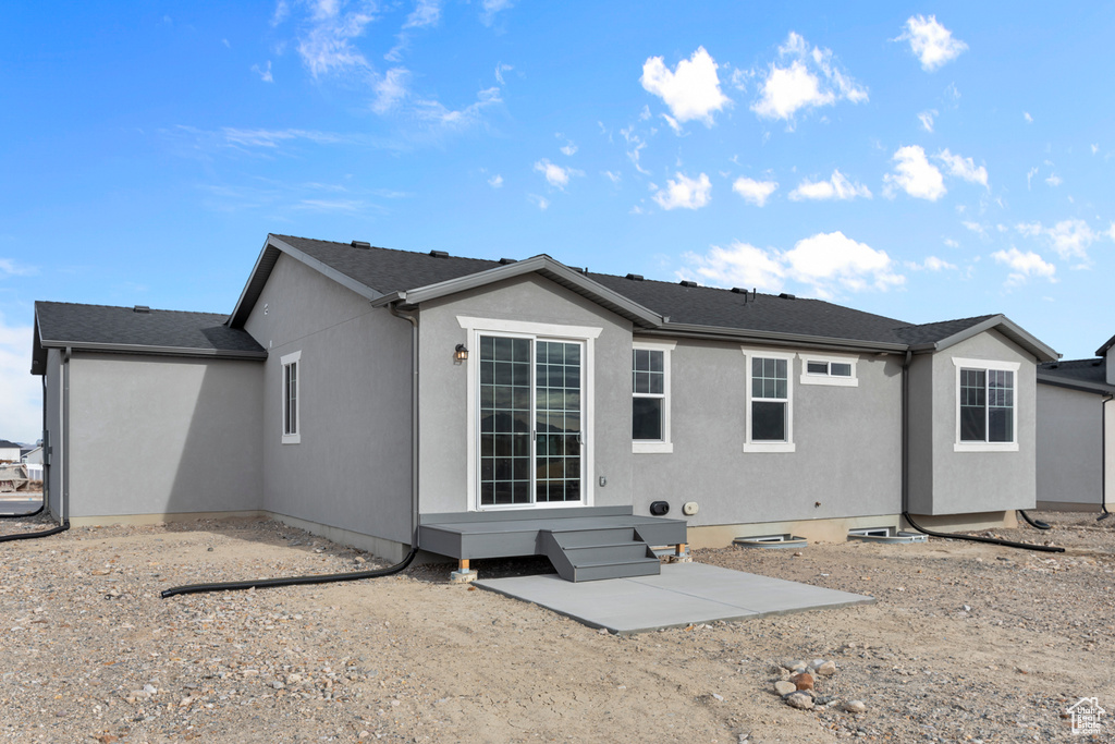 Back of property featuring stucco siding