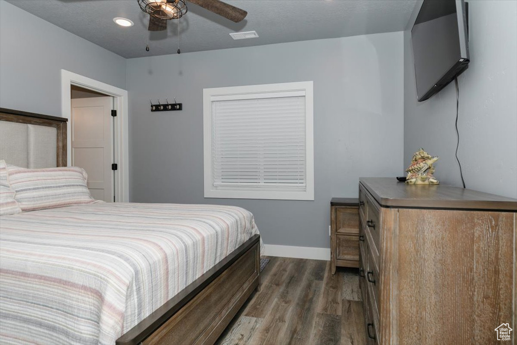 Bedroom featuring wood finished floors and baseboards
