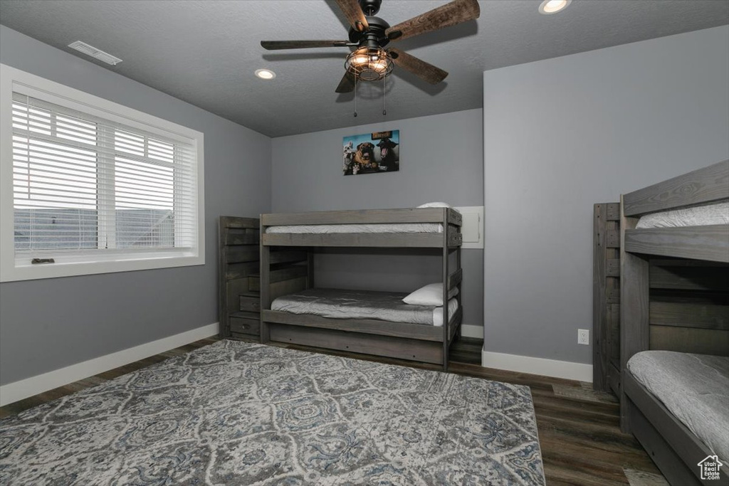 Bedroom with wood finished floors, baseboards, visible vents, and recessed lighting