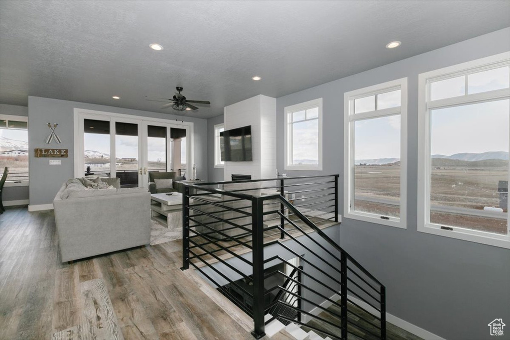 Living area with recessed lighting, baseboards, and a healthy amount of sunlight