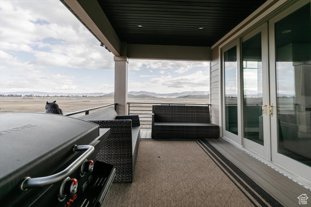 Balcony featuring a mountain view, french doors, and area for grilling