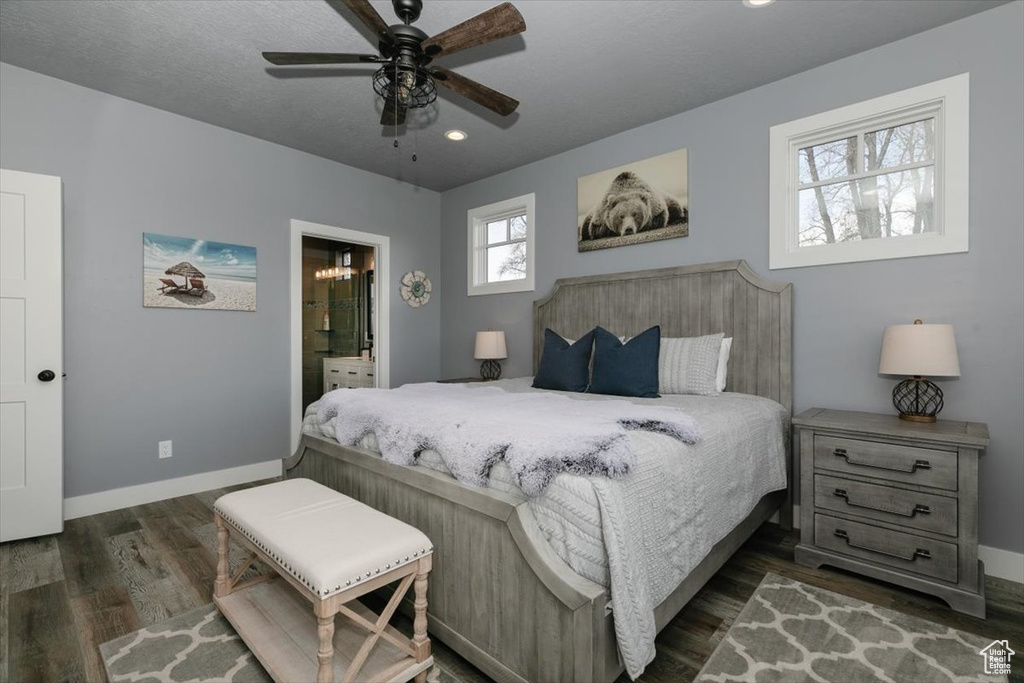 Bedroom featuring baseboards, recessed lighting, ensuite bath, and dark wood-style floors