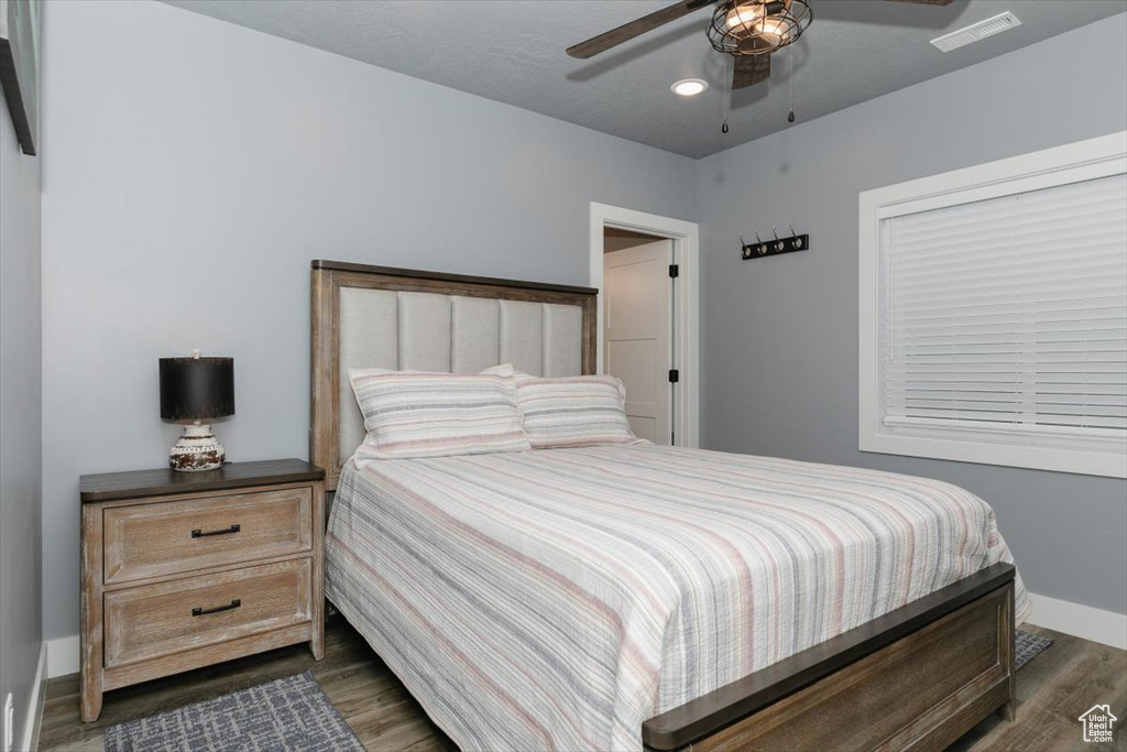 Bedroom featuring baseboards, recessed lighting, a ceiling fan, visible vents, and dark wood finished floors