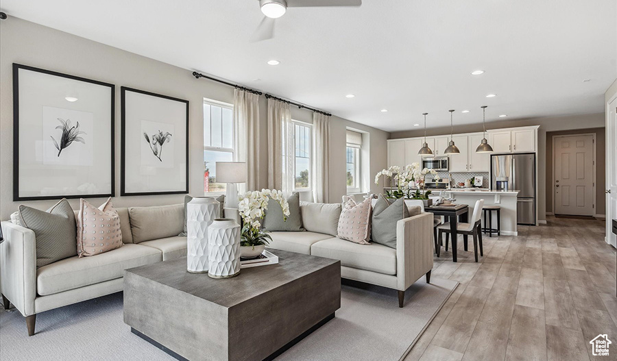 Living area featuring recessed lighting, light wood-style floors, and ceiling fan