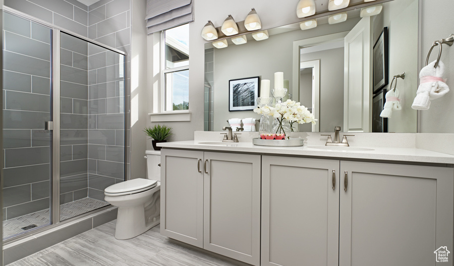 Full bath featuring a sink, plenty of natural light, and a shower stall