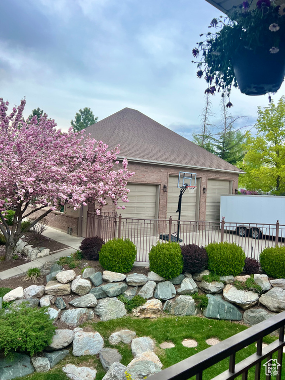 View of yard featuring fence and an attached garage