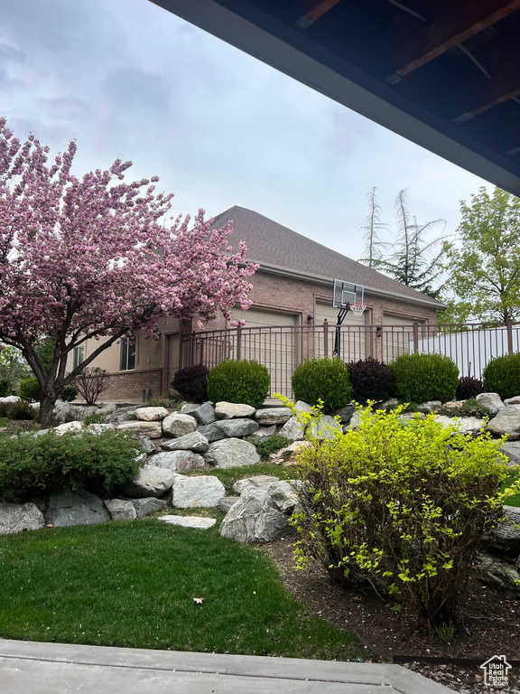 View of yard with fence and an attached garage