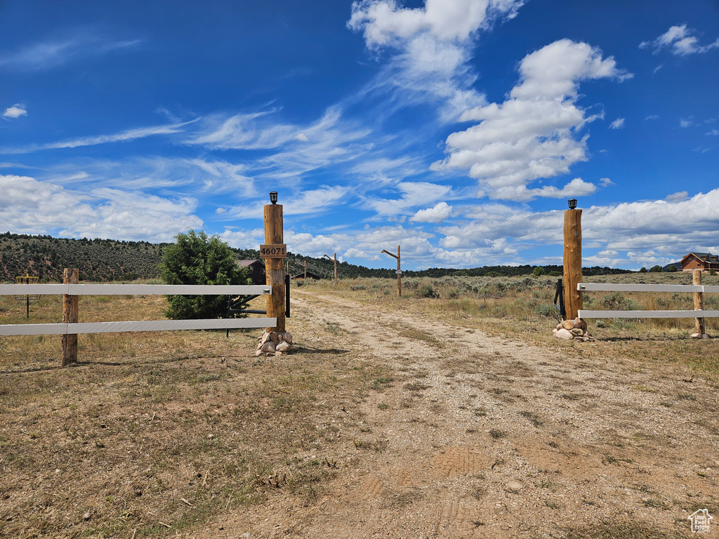 View of yard featuring a rural view and fence