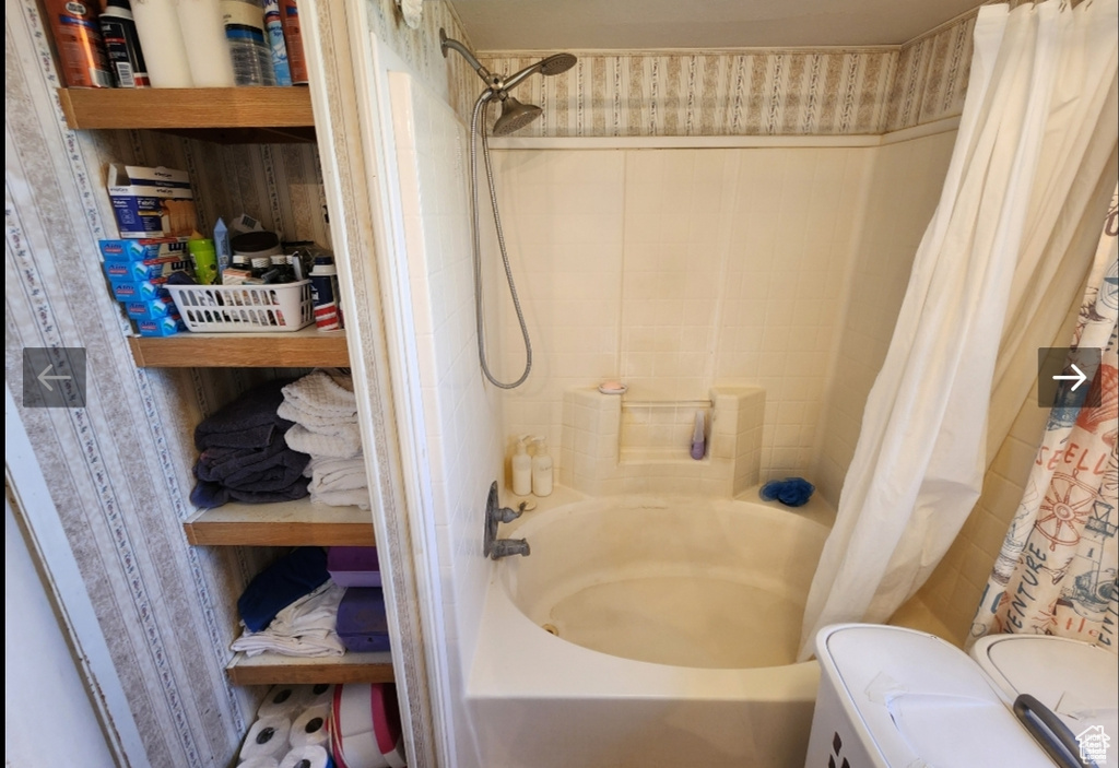 Bathroom with shower / bath combo with shower curtain and toilet