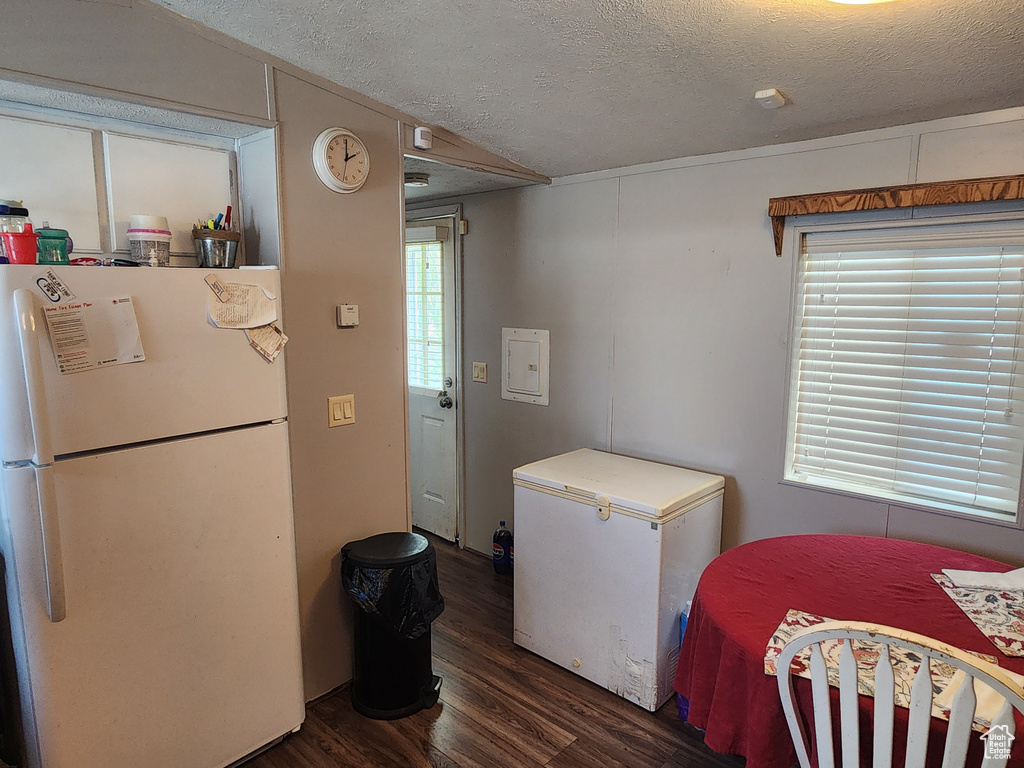 Laundry room with a textured ceiling and wood finished floors