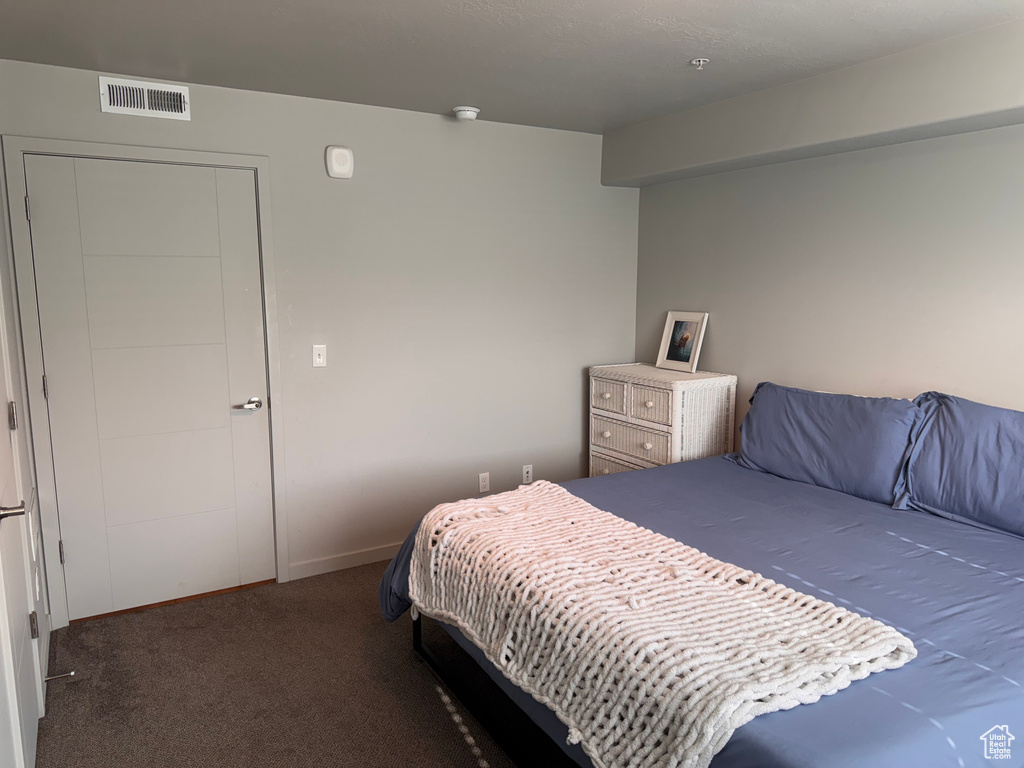 Carpeted bedroom with visible vents