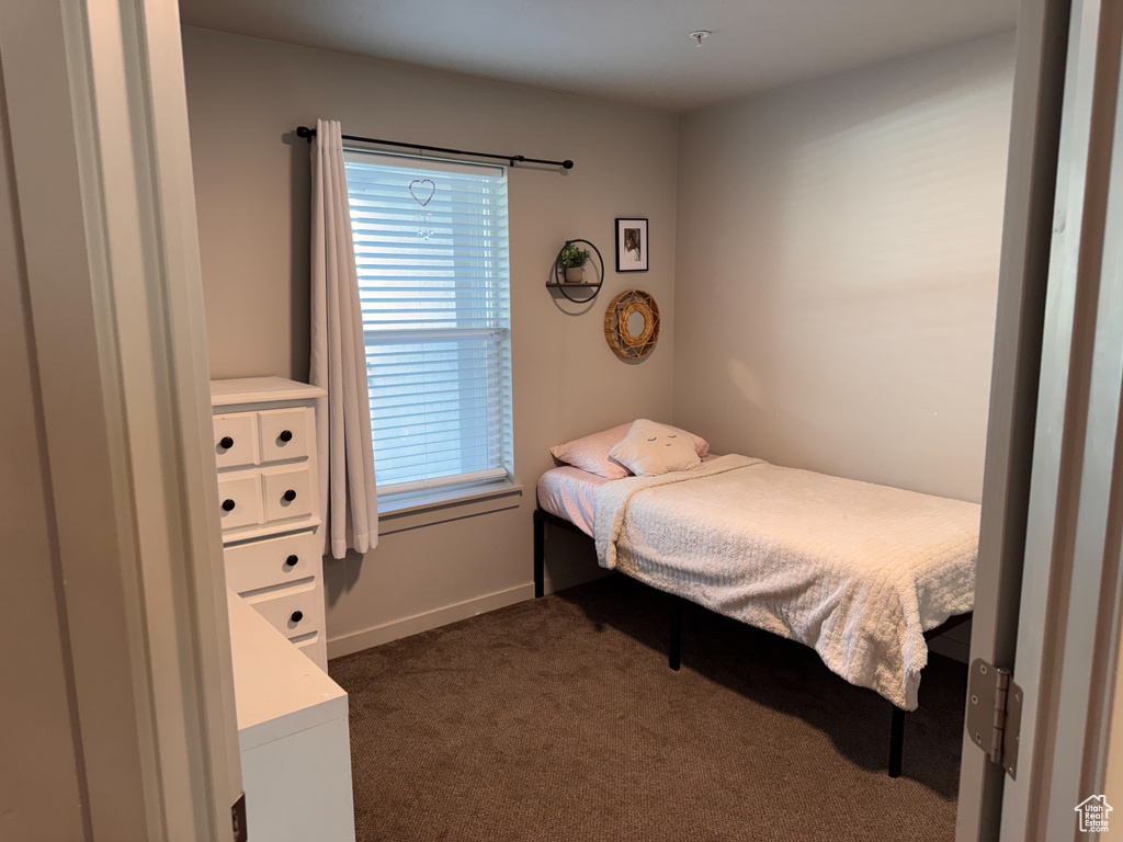 Bedroom featuring dark colored carpet