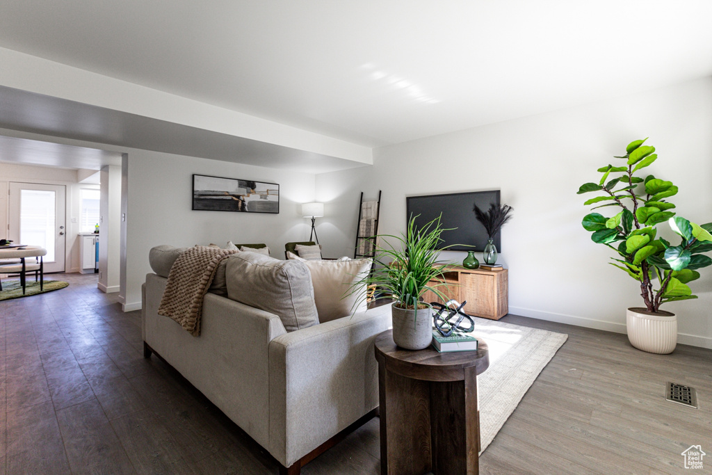 Living room featuring baseboards, wood finished floors, and visible vents