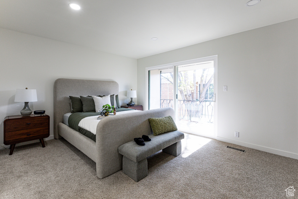 Bedroom featuring recessed lighting, light carpet, access to outside, and visible vents